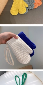 Detail view of colorful knit mittens for kids with warm ribbed texture and neck strap