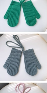 Close-up of thick knitted mittens with vertical corn texture and neck strap