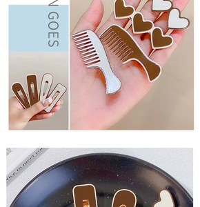 Detailed view of milk tea colored hair clip set with heart and geometric shapes