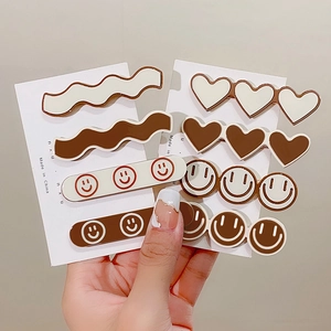 Cute milk tea colored hair clip set with smiley face and heart designs for women