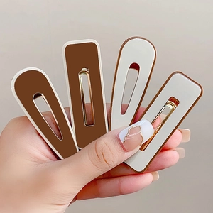 Set of 4 cream and brown acrylic hair clips in rectangular and teardrop shapes