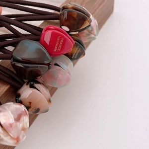 Detailed close-up of handmade tulip acetate hair ties with elegant marble patterns