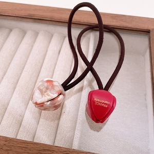 Detail of tulip bud acetate hair ties with golden France Handmade text and marble pattern