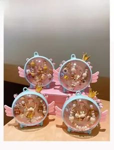 Detail of four blue wings jewelry boxes with golden crowns and colorful cartoon accessories