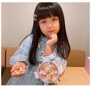 Close-up of young girl wearing cute brown cartoon bear hair clips and accessories set