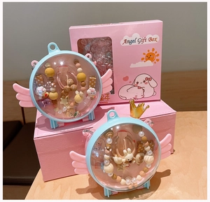 Close-up of cute cartoon hair accessories with angel wing storage boxes and gift packaging