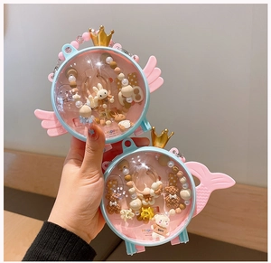 Detailed view of two angel-themed jewelry boxes with colorful bead chains and resin charms