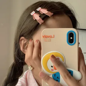 Close-up of matte brown 3D teddy bear hair clips worn by a girl for a cute styling effect
