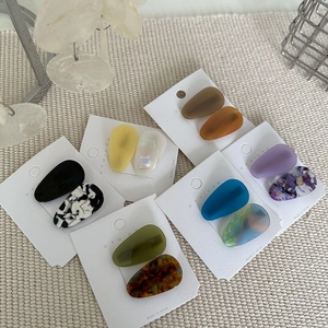 Water drop acetate hair clips in tortoiseshell and marble patterns on display card