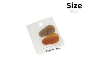 Detailed view of 4cm acetate water-drop hair clips in amber and brown on a display card