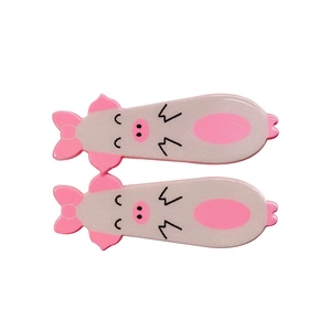 Set of two cute cartoon pig hair clips with bow designs for energetic girls