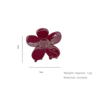 Detail view of 5x4cm burgundy acetate flower hair claw clip with handmade engraving
