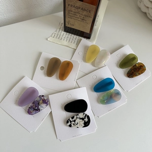 Detail of multi-color acetate hair clips set with matte and marble textures