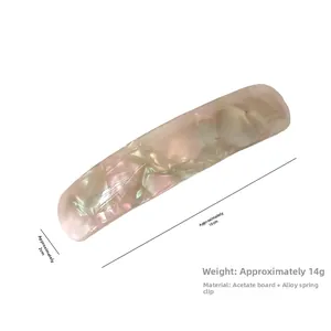 Detail view of pink and white acetate hair clip showing 10cm length and smooth texture