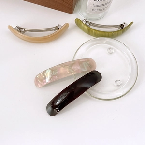 Detailed set of four acetate hair clips in beige, green, pink and brown tones