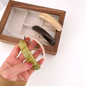 French acetate spring hair clips in marble green, black, and beige colors