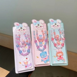 Detail of colorful acrylic beaded necklaces with cute animal pendants in retail packaging