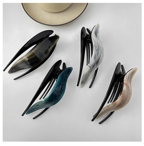 Close-up of acetic acid hair claws with marble texture in four elegant vintage colors
