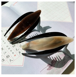 Minimalist acetate hair clips with tortoiseshell and marble texture on art book