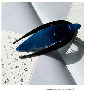 Detail view of a blue acetate hair clip featuring a minimalist layered design and shadows