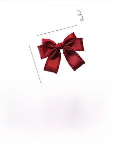 Detail view of a handmade red fabric bow hair clip with pleated edges and dimensions