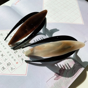 Elegant cellulose acetate hair clips with amber and marble texture in minimalist style