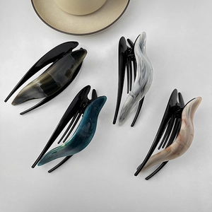 Four large acetate duckbill hair clips with marble textures and minimalist Korean design