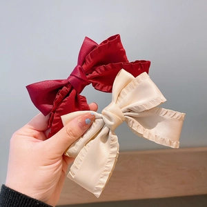 Elegant set of burgundy and cream satin bow hair clips with ruffled edges for hair styling