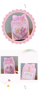 Close-up of DIY beads kit with colorful floral charms and pink heart-shaped storage box