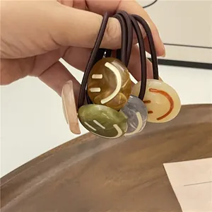 Close-up of durable elastic hair ties with ink-pattern smiley face resin beads