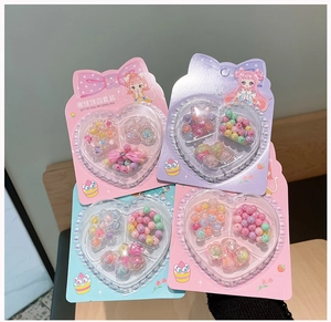 Macro detail of colorful floral DIY bead sets for kids jewelry in heart-shaped packaging