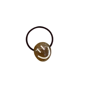 Simple amber resin smiley face elastic hair tie with durable dark brown cord on white background