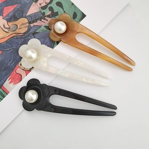 Elegant U-shaped acetate hair pins with floral pearl detail in amber, white and black