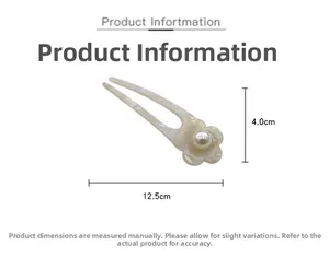 Detail view of a white marble pattern acetate hair pin with pearl flower, 12.5cm length