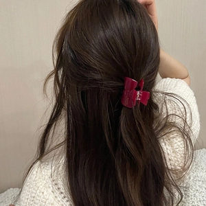Sweet jelly color acetate bow hair claw clip for women shown on a half-up hairstyle
