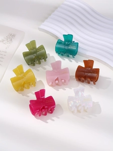 Close-up of colorful bow-shaped acetate hair claws in various sweet jelly tones