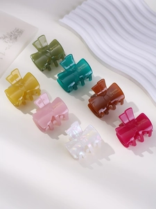 Macro detail of assorted jelly colors bowtie hair claws with Barrette La France engraving