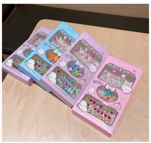 Detailed set of kids' nail stickers, mini hair clips, and rhinestones in cute bunny boxes