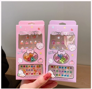 Close-up of kids cartoon nail sticker sets with colorful hair clips and crystal gems