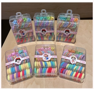 Detail view of colorful kids hair accessories in a portable transparent gift box set