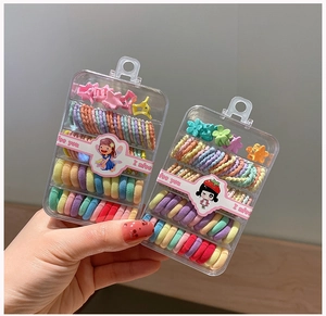Close-up of colorful elastic hair bands and candy-colored hair clips in a portable gift box