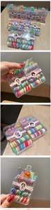 Detail of colorful elastic hair bands and mini claw clips in a transparent storage box