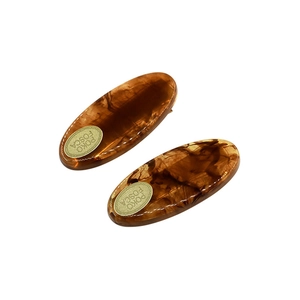 Set of two amber tortoiseshell acetate hair clips with gold logo for girls' side bangs