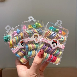 Set of macaron spiral hair ties and mini clips in transparent gift boxes