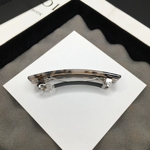 Close-up of leopard acetate hair clip with silver metal base and black anti-slip sleeve