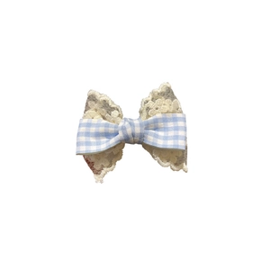 Girl's spring hair clip with lace and blue gingham bow on a white background