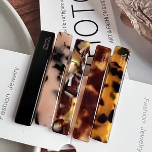 Five-piece acetate hair clip set in tortoiseshell and solid colors for elegant styling
