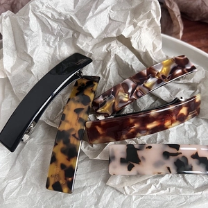 Close-up of assorted tortoise shell acetate hair clips with France Handmade engraving