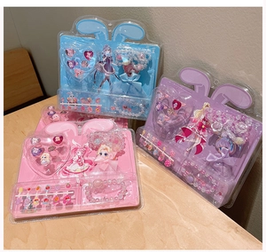 Detail view of pink and blue cartoon princess jewelry set with rings and bead bracelets