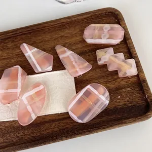 Set of 7 pink geometric hair clips with checkered and striped acrylic patterns
